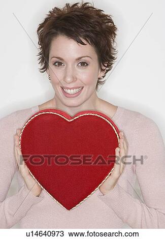 Woman holding heart-shaped box View Large Photo Image Stock Image - Woman holding heart-shaped box. Fotosearch