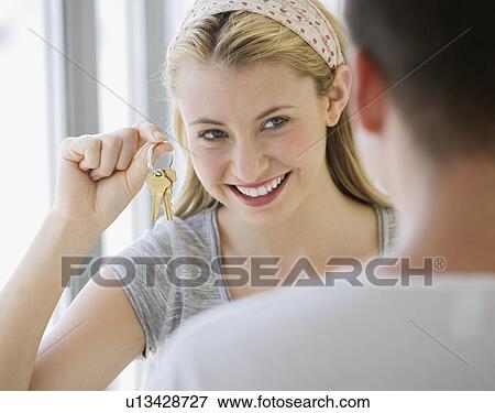 Woman holding house keys View Large Photo Image Stock Photo - Woman holding house keys. Fotosearch