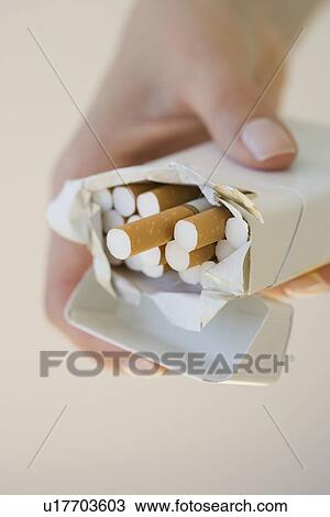 Woman holding open pack of cigarettes View Large Photo Image Stock Image - Woman holding open pack of cigarettes. Fotosearch