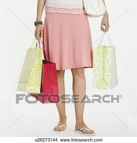 Woman holding shopping bags View Large Photo Image Picture - Woman holding shopping bags. Fotosearch