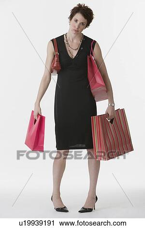Woman holding shopping bags View Large Photo Image Stock Image - Woman holding shopping bags. Fotosearch