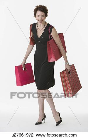 Woman holding shopping bags View Large Photo Image Stock Image - Woman holding shopping bags. Fotosearch