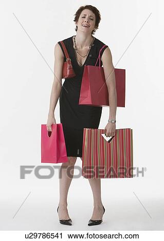 Woman holding shopping bags View Large Photo Image Stock Image - Woman holding shopping bags. Fotosearch