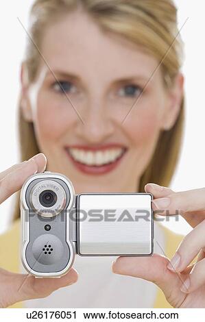 Stock Image - Woman holding small video camera. Fotosearch