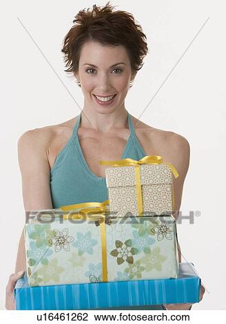 Woman holding stack of gifts View Large Photo Image Stock Image - Woman holding stack of gifts. Fotosearch