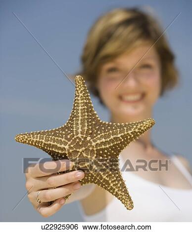 Woman holding starfish View Large Photo Image Stock Photograph - Woman holding starfish. Fotosearch