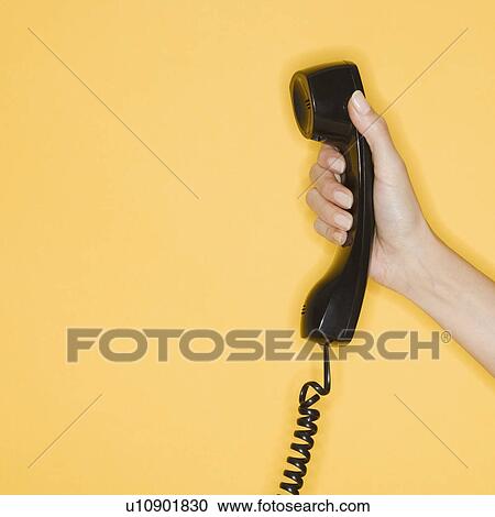 Woman holding telephone receiver View Large Photo Image Stock Image - Woman holding telephone receiver. Fotosearch