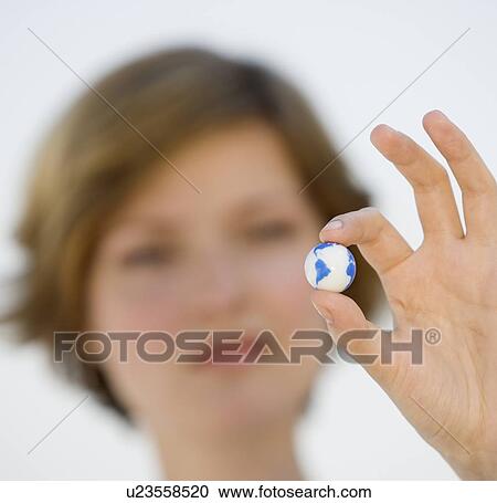 Woman holding tiny globe View Large Photo Image Stock Image - Woman holding tiny globe. Fotosearch