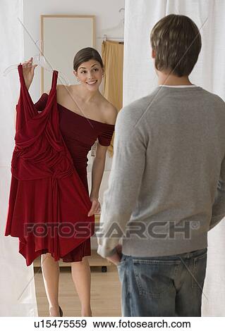 Woman holding up dress for boyfriend View Large Photo Image Stock Photo - Woman holding up dress for boyfriend. Fotosearch