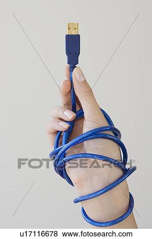 Stock Photo - Woman holding USB cable. Fotosearch