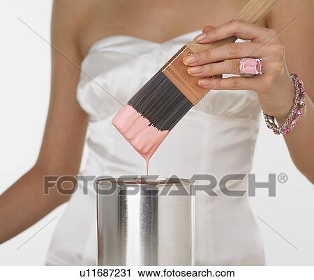 Woman in fancy dress dipping paintbrush in paint can View Large Photo Image Stock Image - Woman in fancy dress dipping paintbrush in paint can. Fotosearch