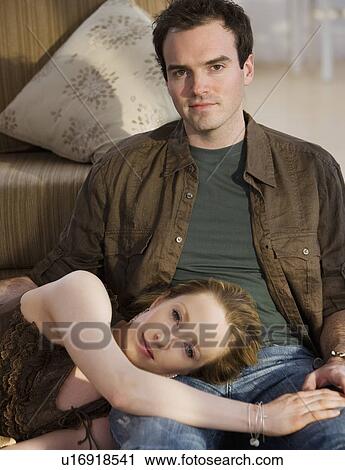 Stock Image - Woman laying head on boyfriend’s lap. Fotosearch