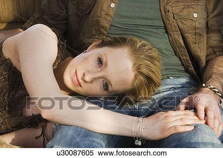 Stock Photography - Woman laying head on boyfriend’s lap. Fotosearch