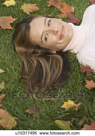 Woman laying in grass View Large Photo Image Stock Photography - Woman laying in grass. Fotosearch
