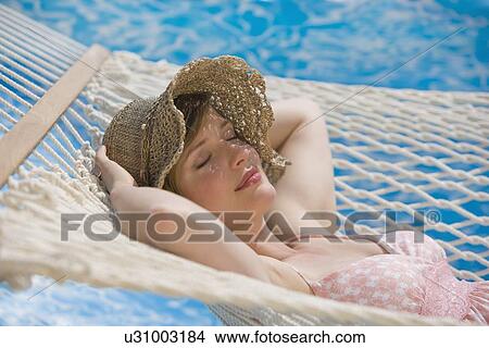 Woman laying in hammock View Large Photo Image Picture - Woman laying in hammock. Fotosearch