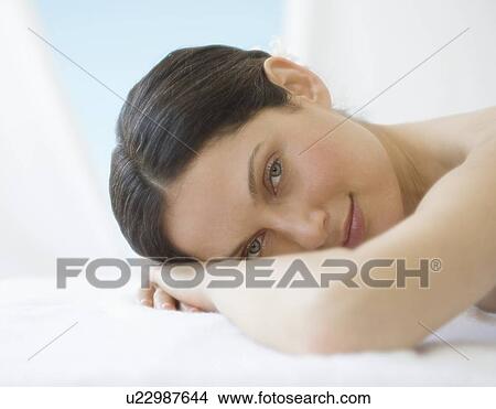 Picture - Woman laying on spa table. Fotosearch