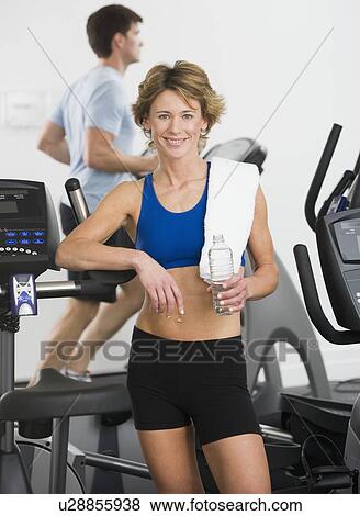 Woman leaning on treadmill View Large Photo Image Stock Photo - Woman leaning on treadmill. Fotosearch
