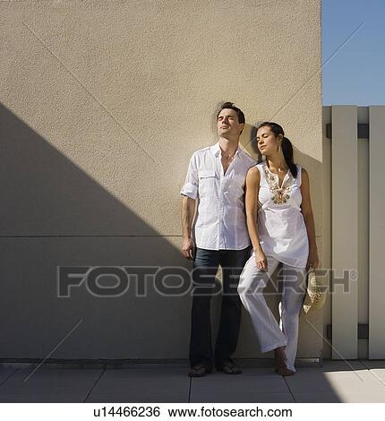 Woman leaning on wall in sunlight View Large Photo Image Stock Photograph - Woman leaning on wall in sunlight. Fotosearch