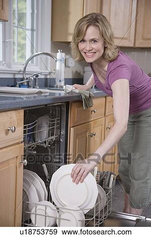 Woman loading dishwasher View Large Photo Image Stock Photo - Woman loading dishwasher. Fotosearch