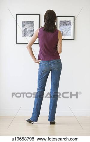 Woman looking at artwork in gallery View Large Photo Image Stock Photo - Woman looking at artwork in gallery. Fotosearch