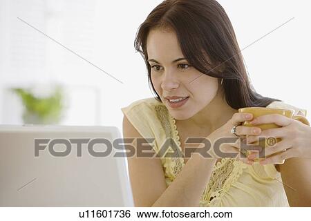 Stock Photograph - Woman looking at computer. Fotosearch