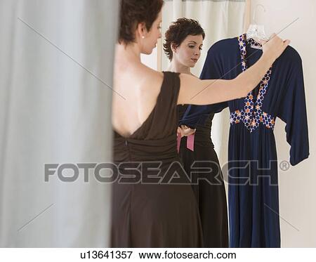 Woman looking at dress View Large Photo Image Stock Photo - Woman looking at dress. Fotosearch