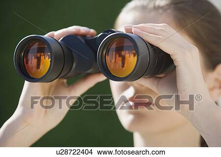 Picture - Woman looking through binoculars. Fotosearch