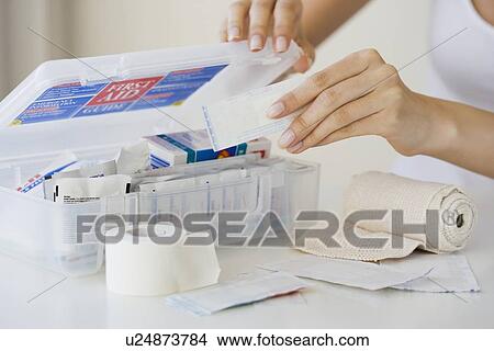 Woman packing first aid kit View Large Photo Image Picture - Woman packing first aid kit. Fotosearch