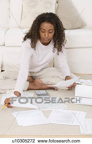 Woman paying bills on floor View Large Photo Image Stock Image - Woman paying bills on floor. Fotosearch