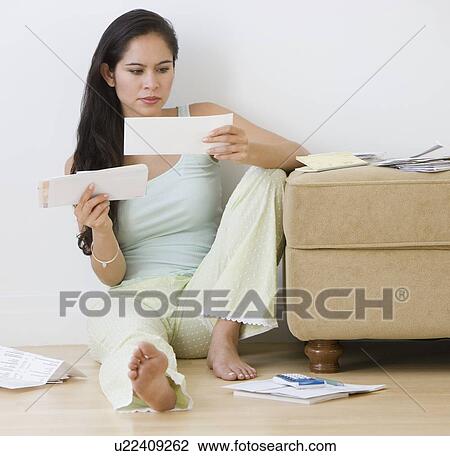 Stock Image - Woman paying bills. Fotosearch