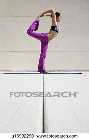 Stock Image - Woman practicing yoga. Fotosearch