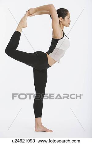 Stock Image - Woman practicing yoga. Fotosearch