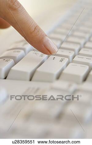 Woman pressing Enter key on computer keyboard View Large Photo Image Stock Image - Woman pressing Enter key on computer keyboard. Fotosearch