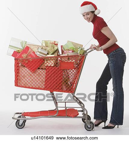 Woman pushing shopping cart of gifts View Large Photo Image Stock Photo - Woman pushing shopping cart of gifts. Fotosearch