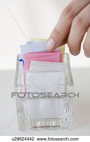 Woman reaching for sweetener packet View Large Photo Image Stock Image - Woman reaching for sweetener packet. Fotosearch