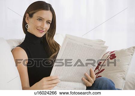 Stock Photograph - Woman reading newspaper. Fotosearch