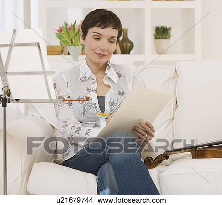 Picture - Woman reading violin sheet music. Fotosearch