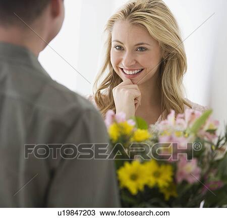 Woman receiving flowers from boyfriend View Large Photo Image Stock Image - Woman receiving flowers from boyfriend. Fotosearch
