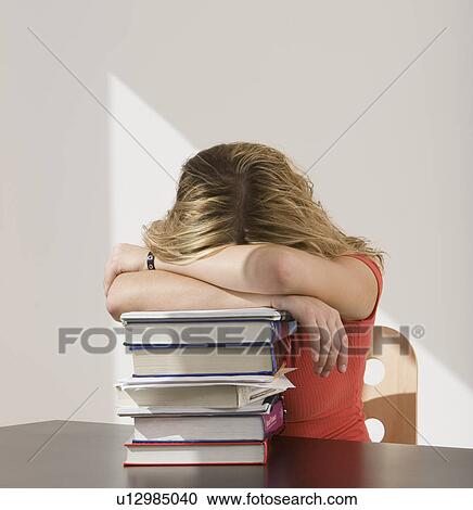 Woman resting head on stack of books View Large Photo Image Stock Image - Woman resting head on stack of books. Fotosearch
