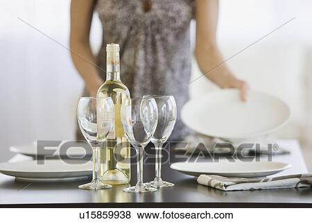 Stock Photo - Woman setting table. Fotosearch