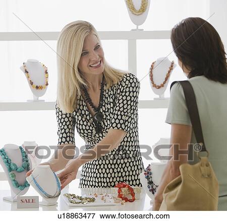 Woman shopping in jewelry store View Large Photo Image Stock Photo - Woman shopping in jewelry store. Fotosearch