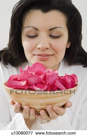 Woman smelling bowl of flower petals View Large Photo Image Stock Photo - Woman smelling bowl of flower petals. Fotosearch