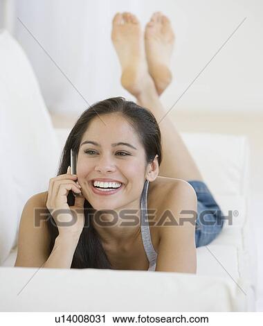 Stock Image - Woman talking on cell phone. Fotosearch