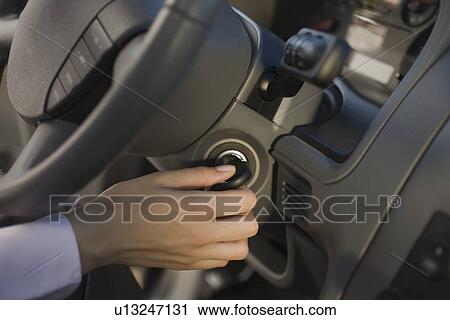 Woman turning car key in ignition View Large Photo Image Stock Image - Woman turning car key in ignition. Fotosearch