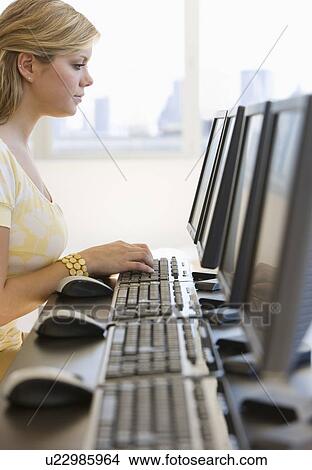 Picture - Woman typing on computer. Fotosearch