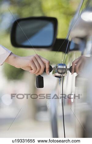 Stock Photography - Woman unlocking car door. Fotosearch