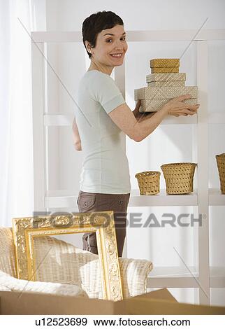 Woman unpacking moving boxes View Large Photo Image Stock Photo - Woman unpacking moving boxes. Fotosearch