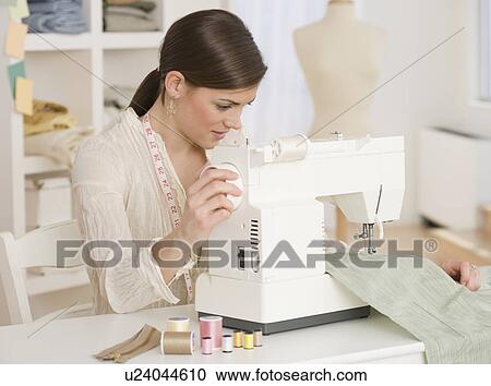 Woman using sewing machine View Large Photo Image Stock Image - Woman using sewing machine. Fotosearch