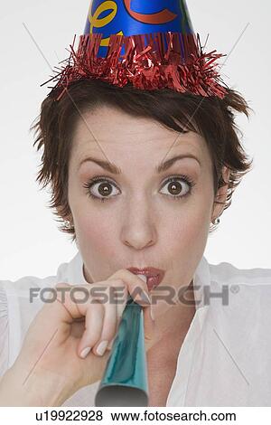 Stock Photo - Woman wearing party hat. Fotosearch