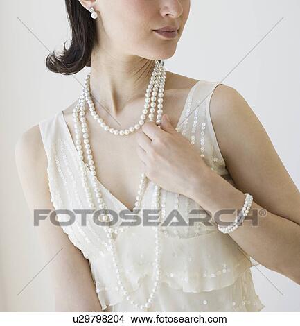 Picture - Woman wearing pearl jewelry. Fotosearch